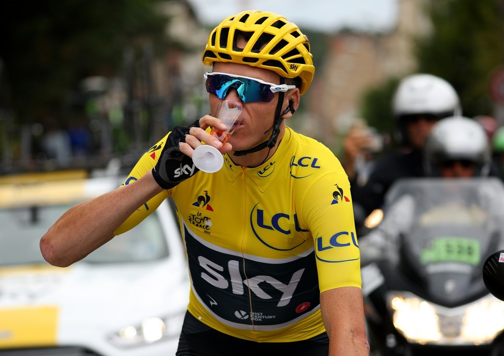 Chris Froome enjoys a glass of champagne as he rides the final stage of the 2017 Tour de France ©Getty Images