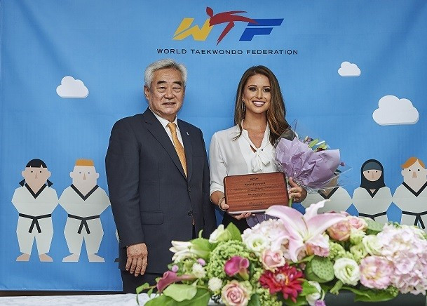 Nia Sanchez was presented with a plague to mark her appoinment by WTF President Chungwon Choue ©WTF