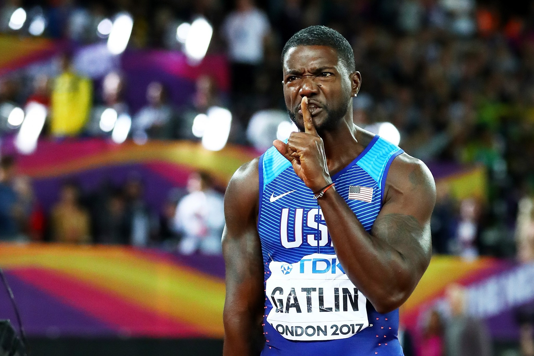 Justin Gatlin raises his finger to his lips after his shock victory ©Getty Images