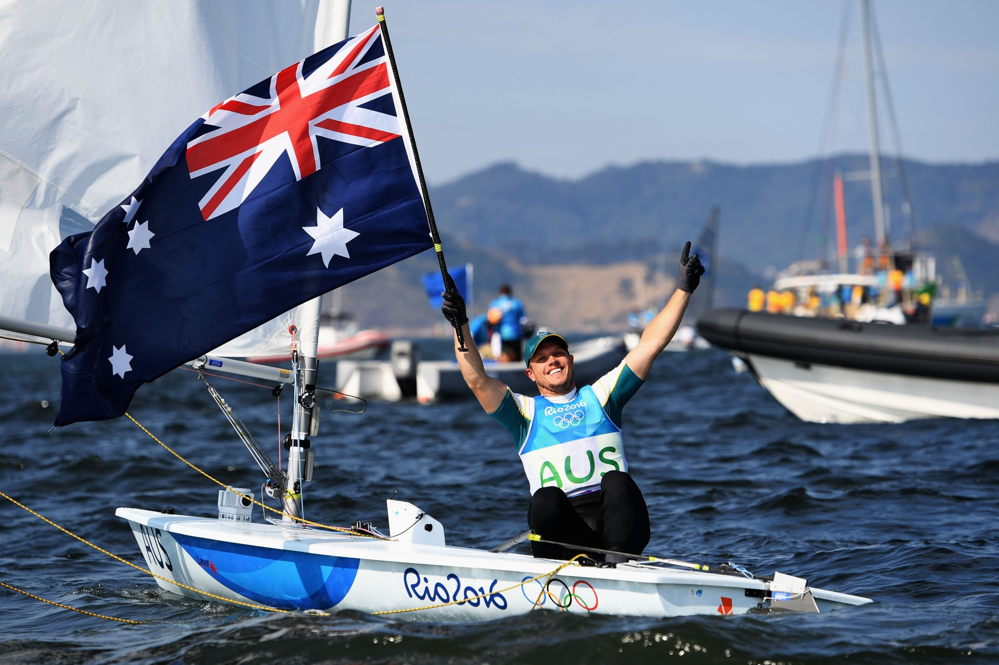 Tom Burton, pictured celebrating Olympic gold, leads in the laser class ©Getty Images
