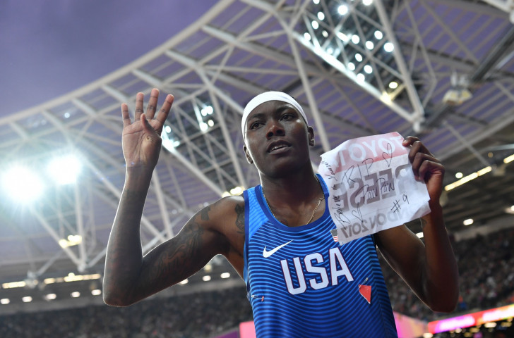 America's Brittney Reese, winner of the women's world long jump title for the fourth time, displays a message to her late grandfather written on the back of her vest number ©Getty Images