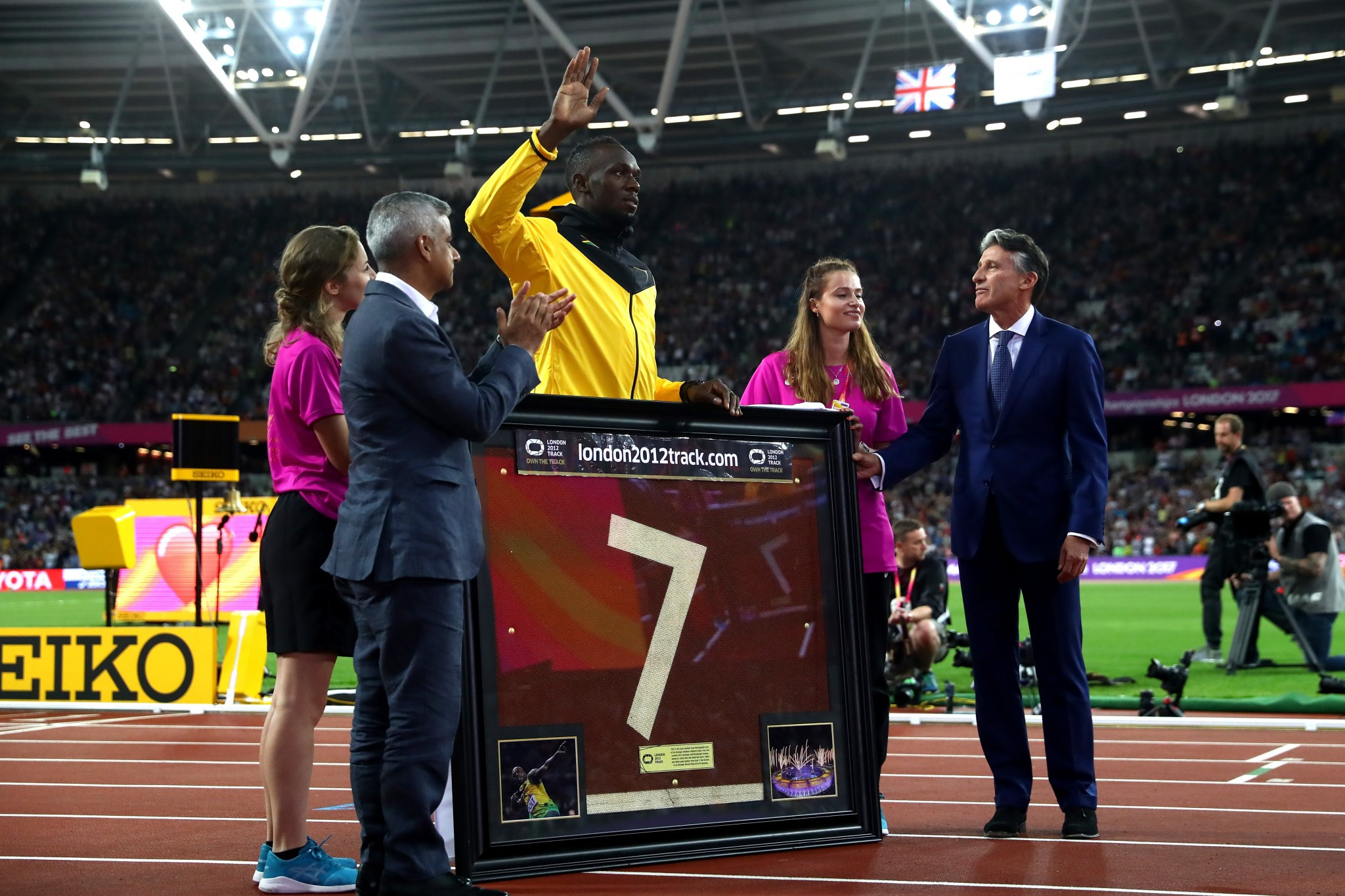Usain Bolt was presented with a portion of the London 2012 track during his lap of honour ©Getty Images