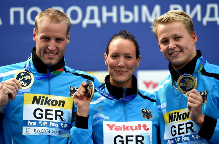 Christian Reichert (left), Isabelle Harle (centre) and Rob Muffels (right) won gold for Germany in the five kilometres mixed team swimming event