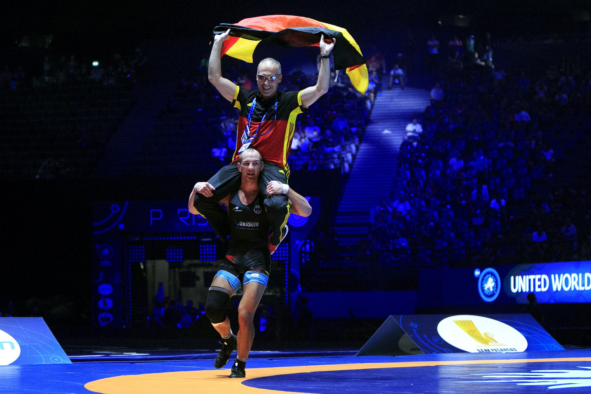 Stäbler celebrated his victory at 71kg along with his coach ©UWW