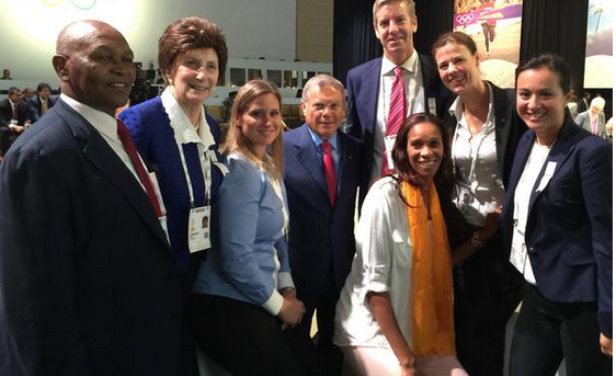 Sir Martin Sorrell poses with a group of Olympic medallists following his keynote speech to the IOC Session 