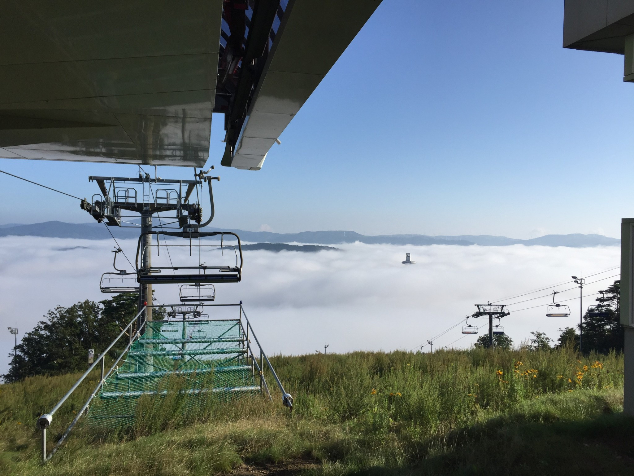 A view into the mist-strewn valley where the Alpensia hub is housed and where he top of the ski jumping tower for Pyeongchang 2018 is just visible above the clouds ©Lorna Campbell