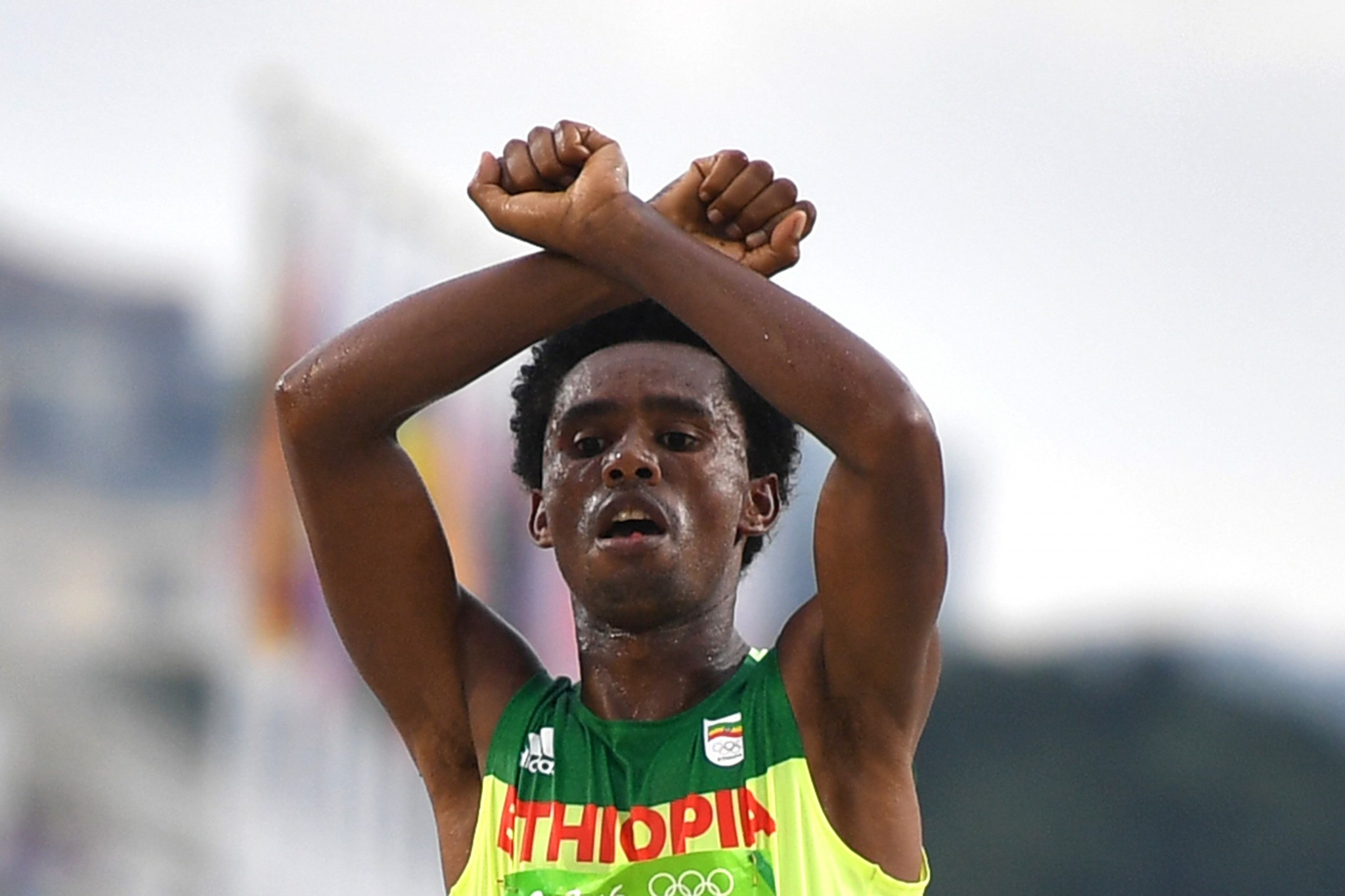 Feyisa Lilesa, pictured showing solidarity with his Oromo people in taking Olympic marathon silver last summer, will give Mo Farah a run for his money at tomorrow's Great North Run ©Getty Images
