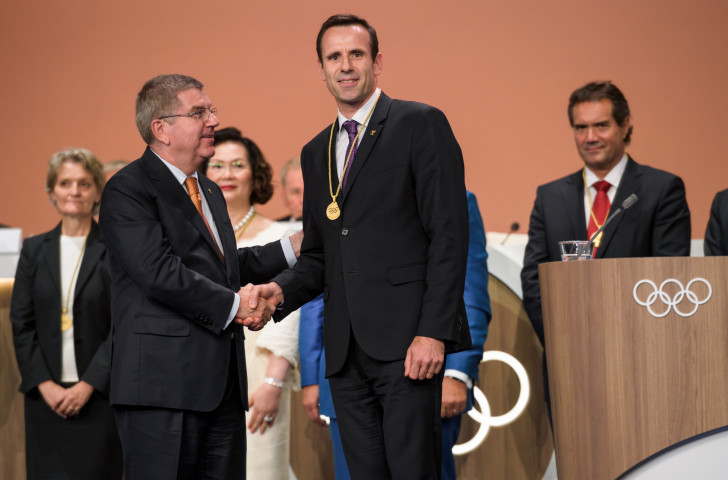 FISA President Jean-Christophe Rolland, pictured receiving IOC membership from Thomas Bach at this month's Congress in Lima, has fears for lightweight rowing's Olympic future ©Getty Images
