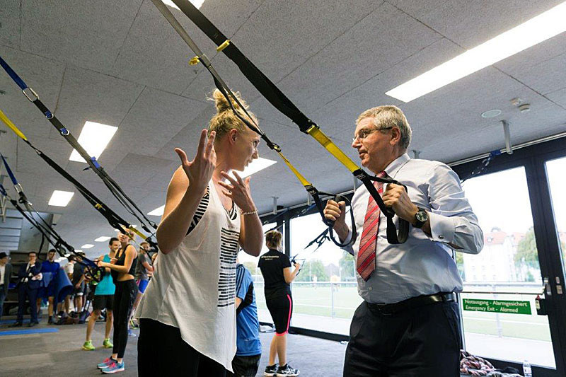 IOC President Thomas Bach receives TRX instruction from Anastasjia Tetereva during his visit to the University of St Gallen ©FISU
