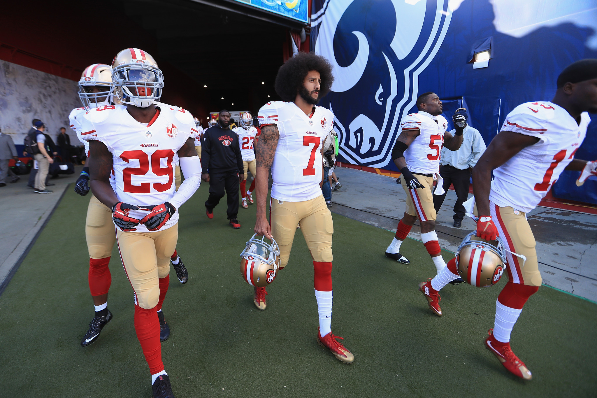 Colin Kaepernick, centre, began a protest on perceived racial injustice last year, but has since found himself without a team ©Getty Images