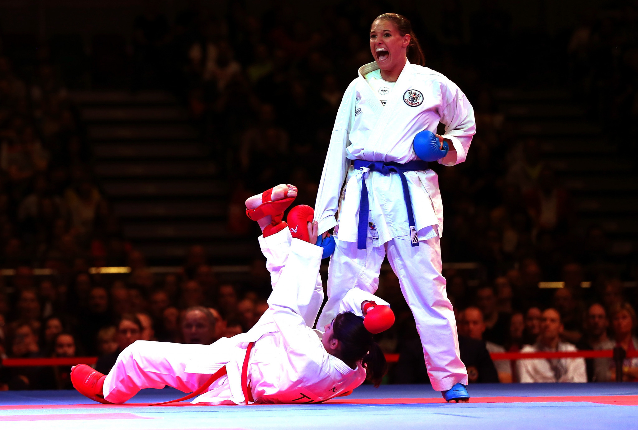 Alisa Buchinger, right, pictured competing at the 2014 World Championships. enjoyed a home victory today ©WKF
