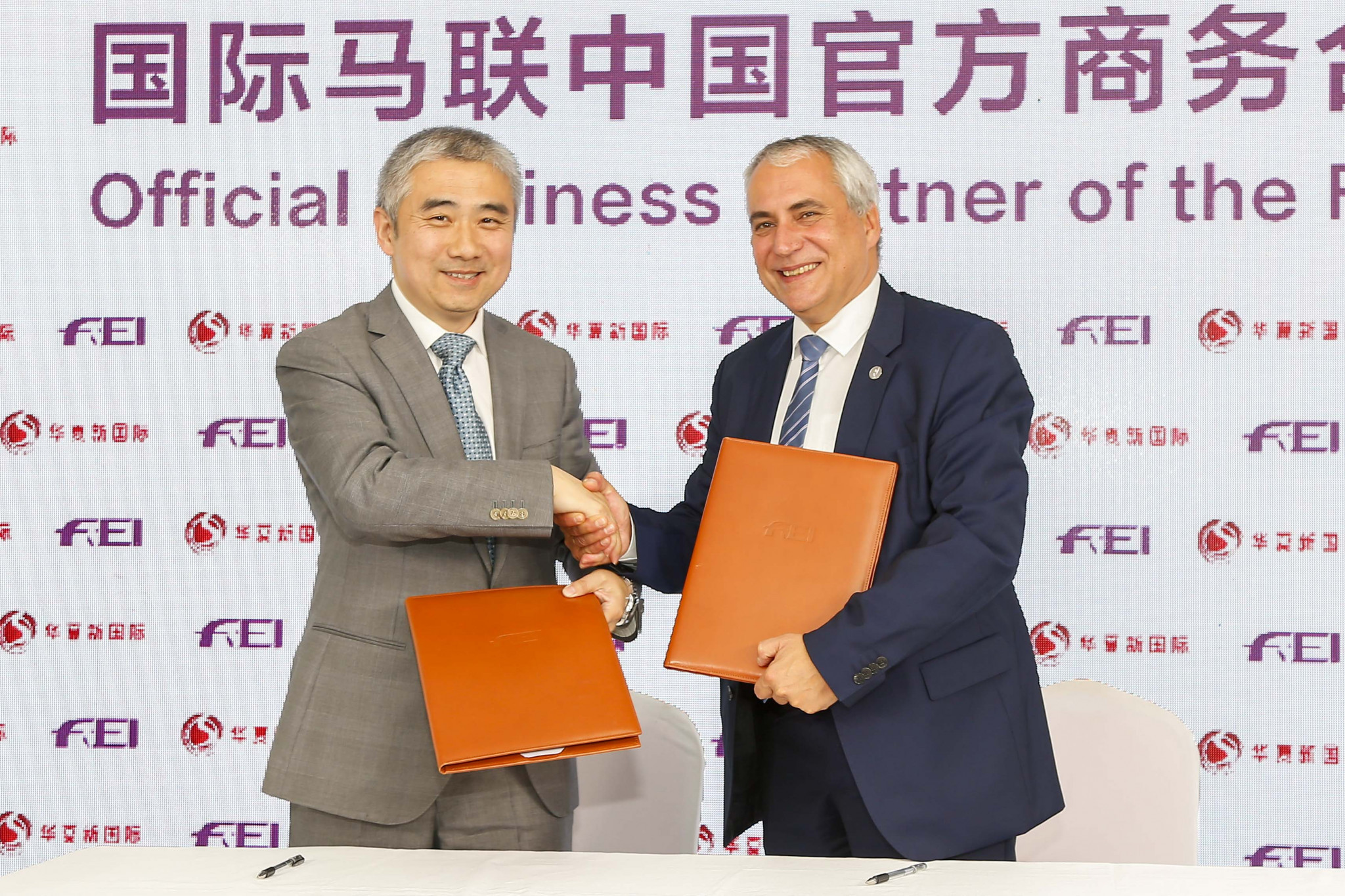 Sun Liming, left, executive director of China National Sports International, alongside FEI President Ingmar De Vos ©FEI