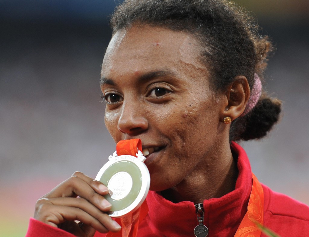 Turkey's Elvan Abbeylegesse, pictured with the Beijing 2008 Olympic 500m silver medal, stands to lose it - and two other silvers - after being confirmed as one of the IAAF's 28 athletes implicated in doping via re-testing ©Getty Images