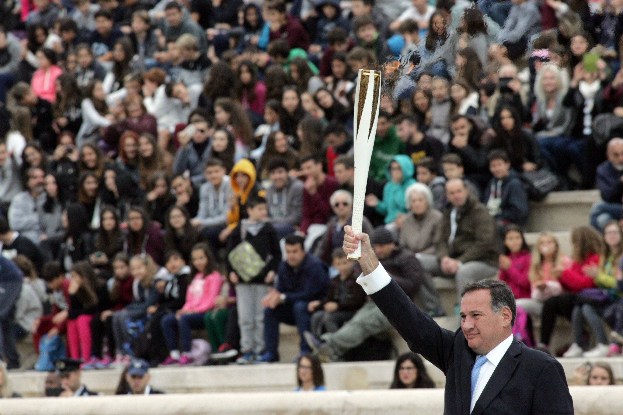 Greek Olympic Committee President Spyros Kapralos holds a Torch aloft during today's ceremony ©Getty Images