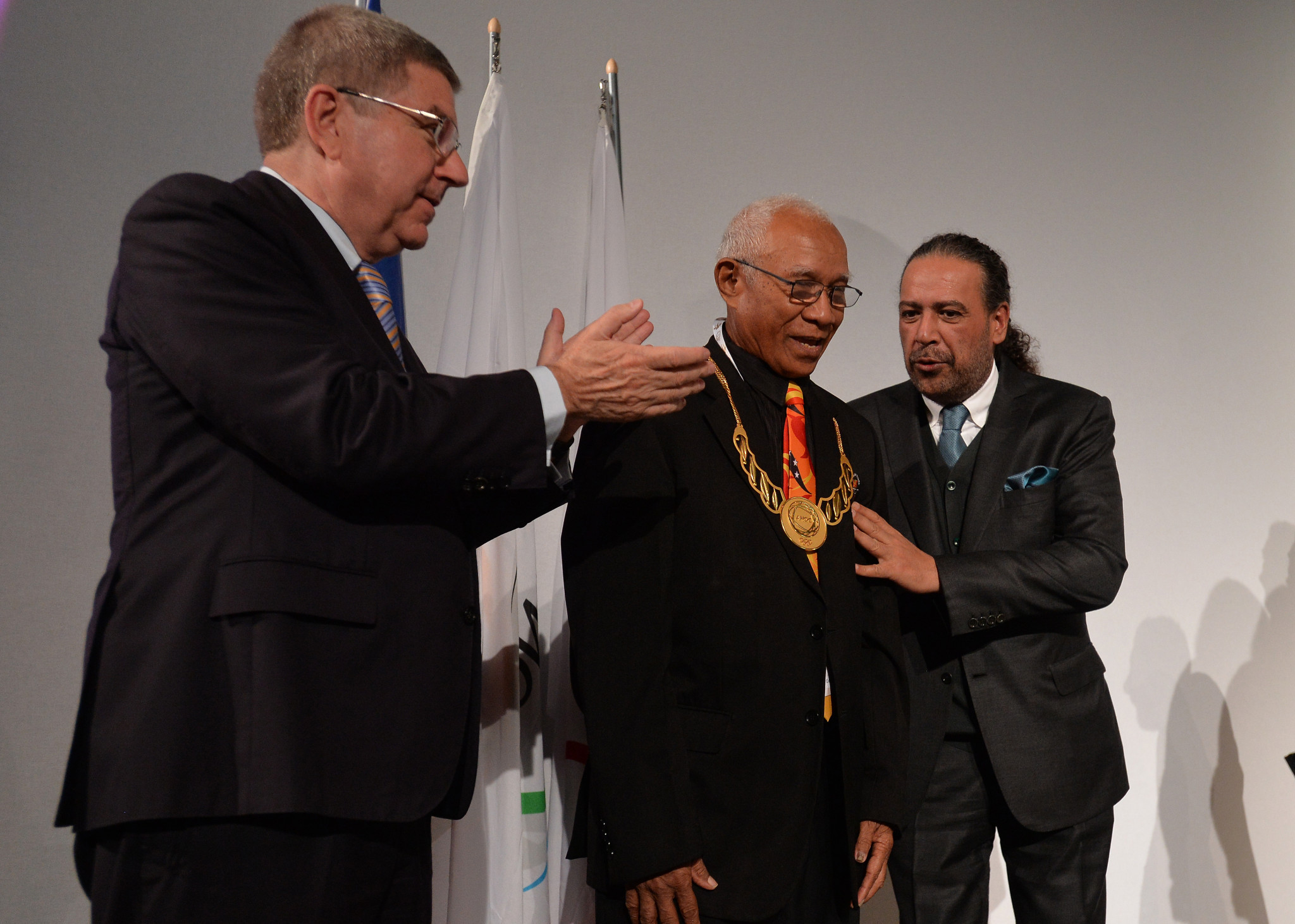 Sir John Dawanincura of Papua New Guinea, centre, receives the ANOC Merit Award ©Getty Images