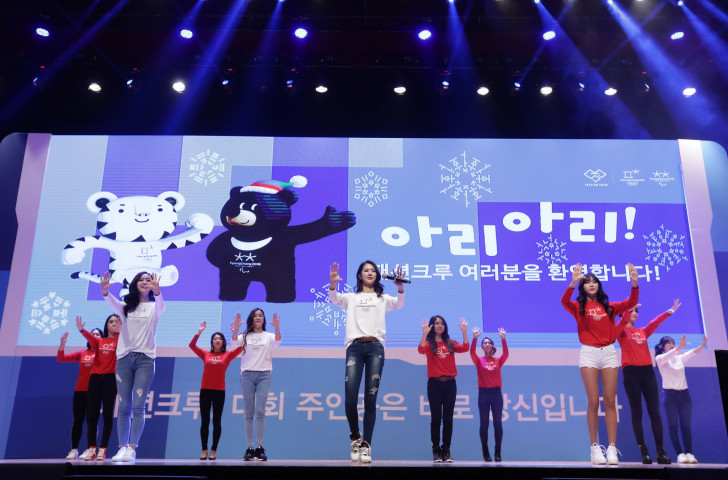 Volunteers for the Pyeongchang 2018 showing off the newly designed uniforms - IPC President Andrew Parsons hopes ticket sales for the Paralympic Games will soon begin to have a similar impact ©Getty Images