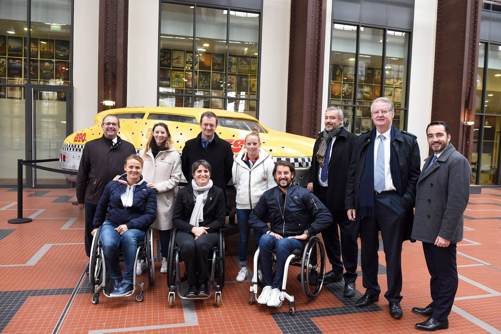 IPC President Andrew Parsons, back row, third left, at the Cité du Cinéma in Saint-Denis which will form part of the Athletes' Village and includes a prop from Luc Besson’s science fiction film The Fifth Element ©Paris 2024