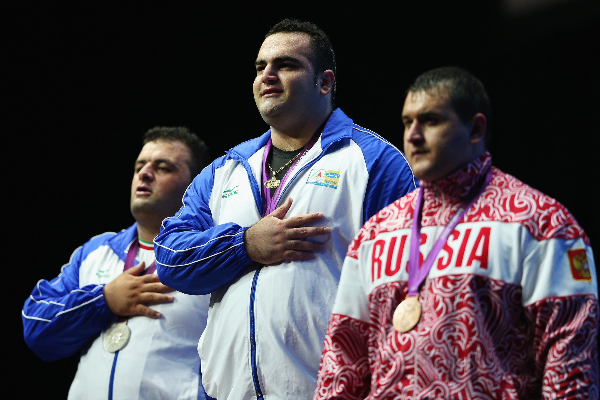Ruslan Albegov, right, pictured with his two fellow medallists from Iran celebrating Olympic bronze at London 2012 ©Getty Images