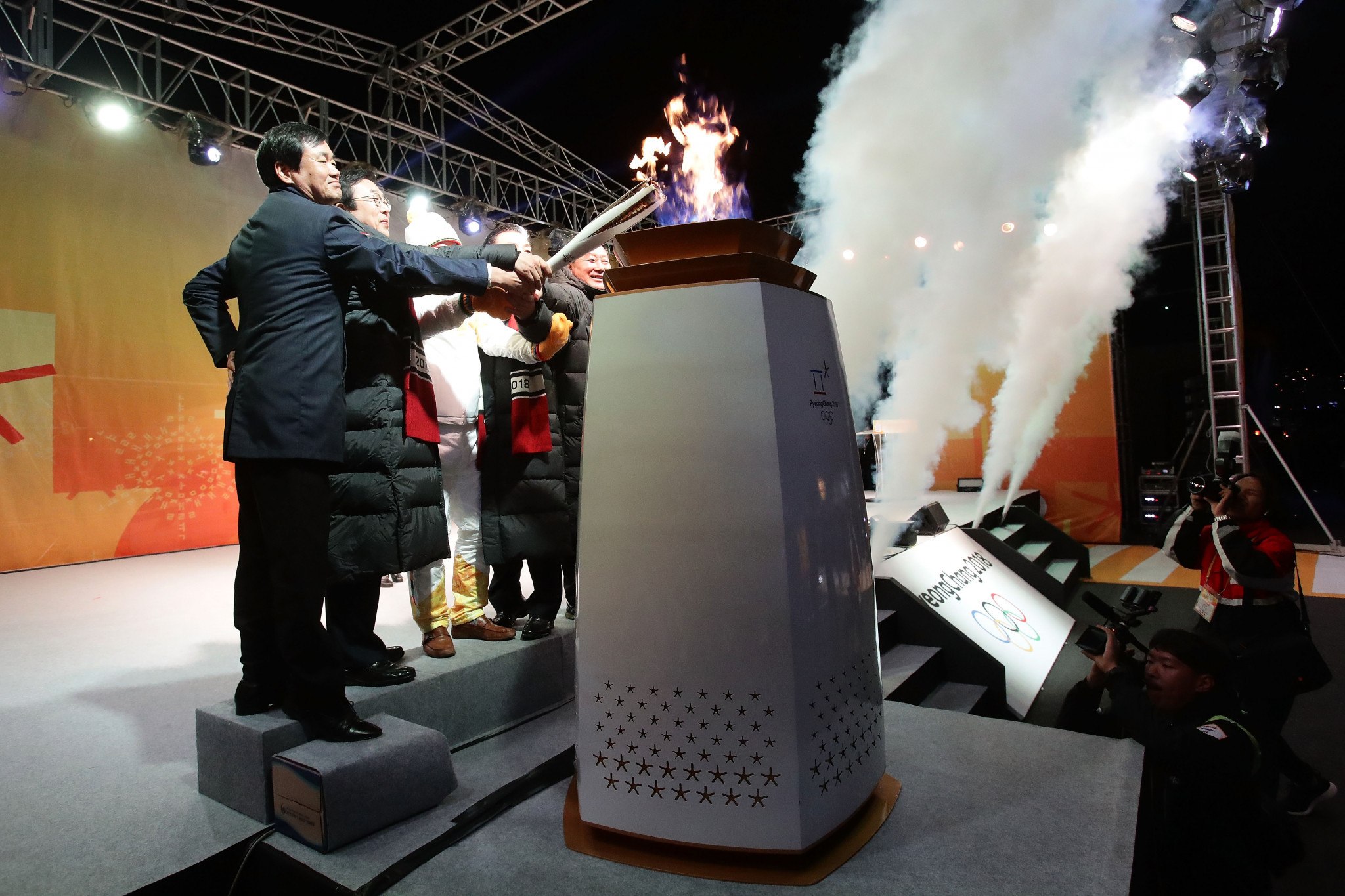 Torchbearer Yang Jung-mo lights the flame during the Pyeongchang 2018 Torch Relay in Busan ©Getty Images