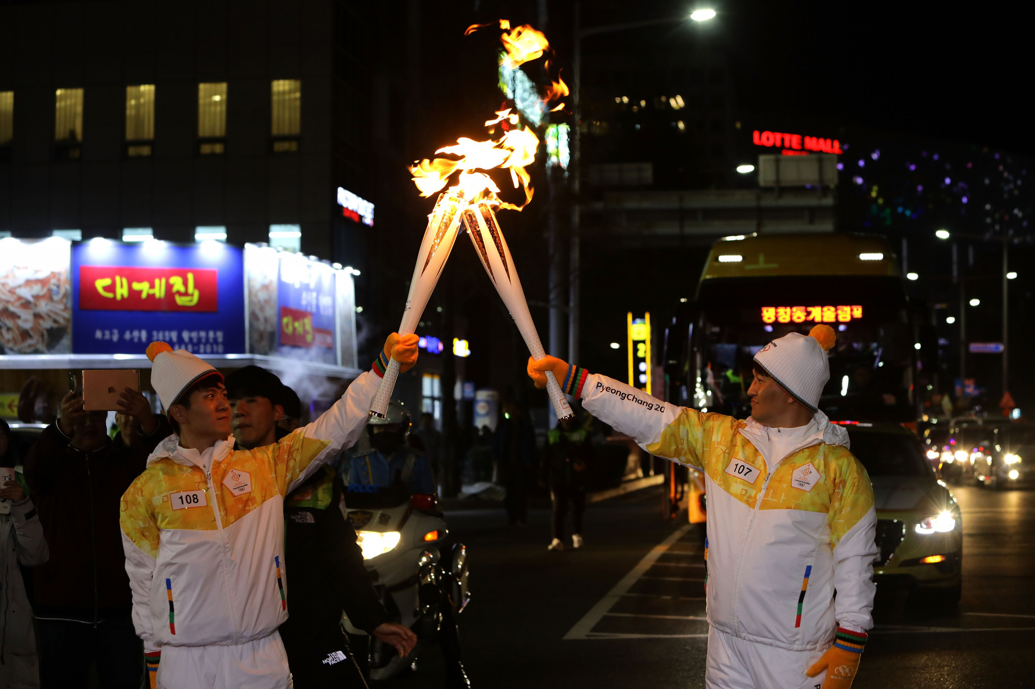 Torchbearers hold the Pyeongchang 2018 flame during its journey through South Korea ©Getty Images