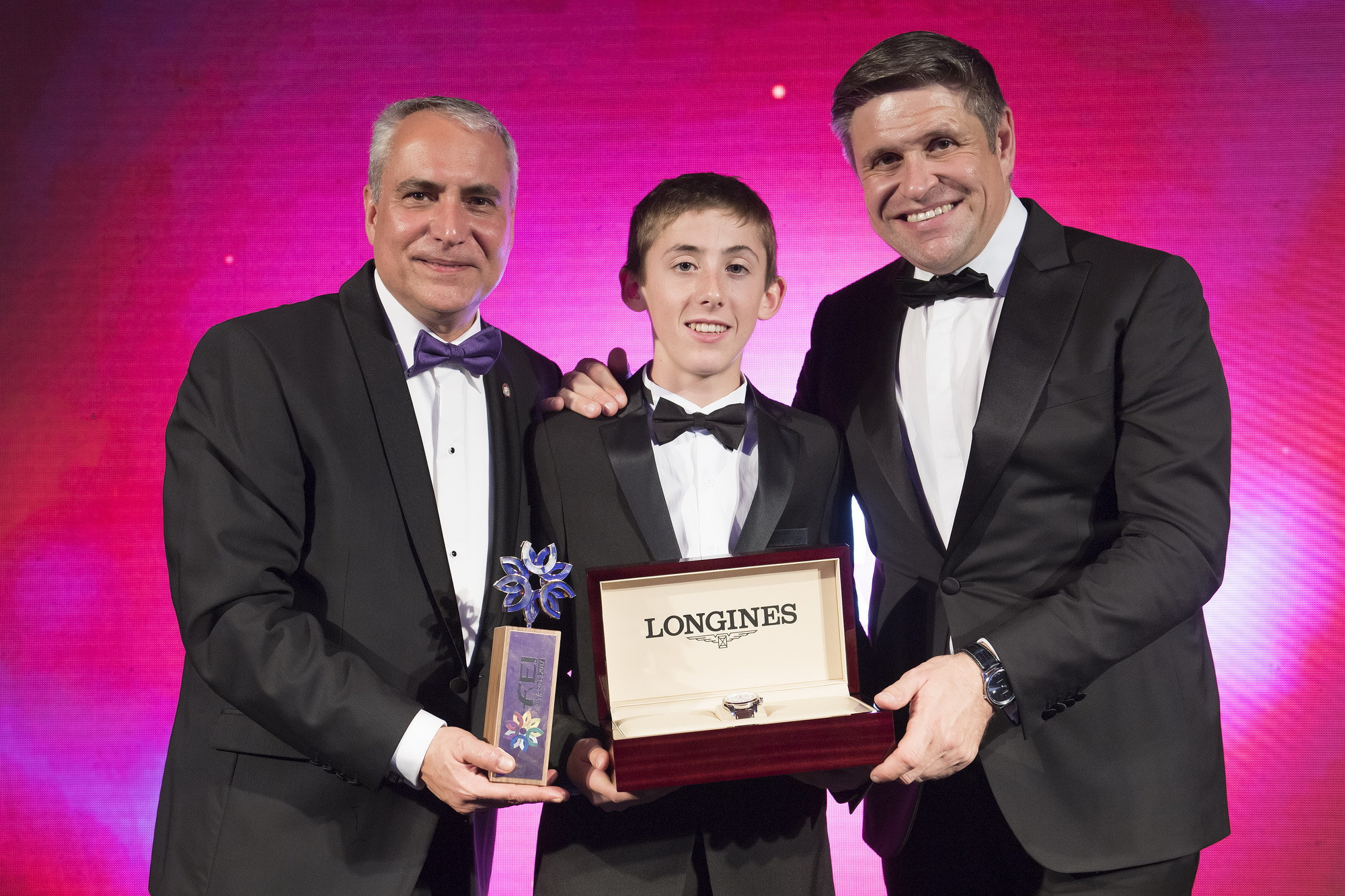 Ireland's Harry Allen, winner of the Longines Rising Star Award, pictured with FEI President Ingmar de Vos, left, and vice- president and head of international marketing Juan-Carlos Capelli at the FEI Awards in Montevideo ©FEI
