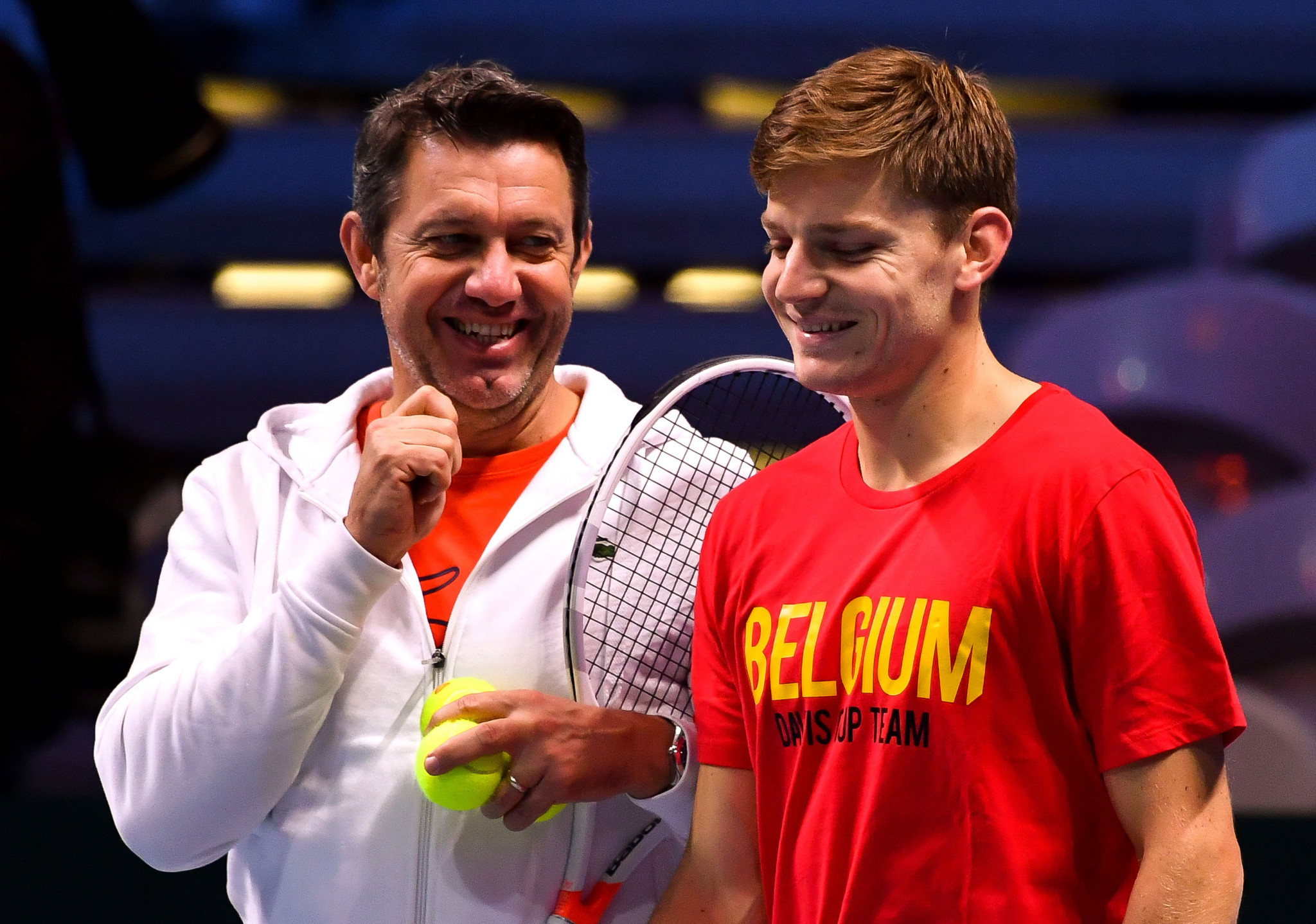 Belgium Davis Cup team coach Thierry Van Cleemput, left, jokes with star player David Goffin during a training session at the Pierre-Mauroy stadium ahead of the World Group final between France and Belgium ©Getty Images