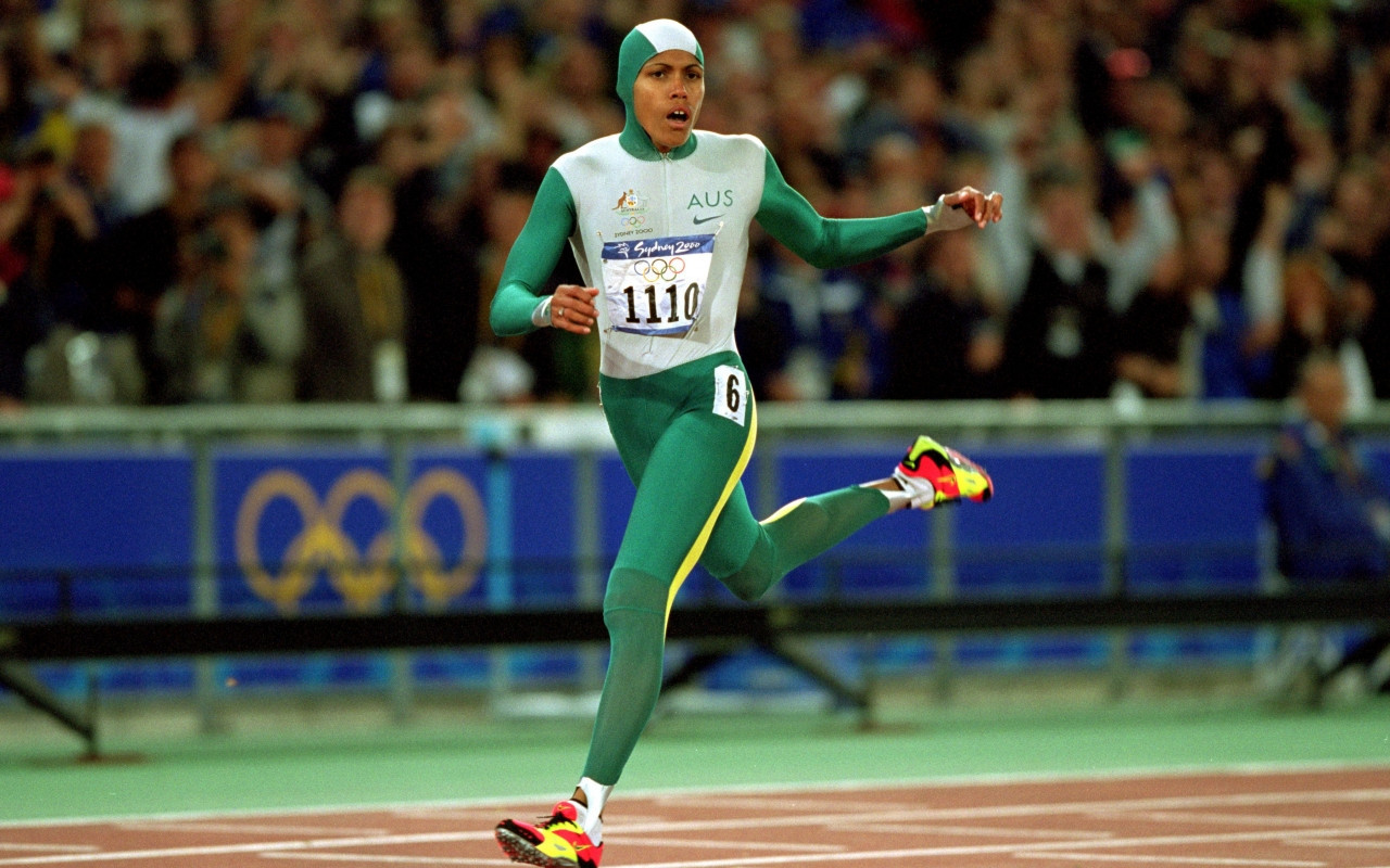Cathy Freeman, carrying Australian colours on her running suit and Aboriginal colours on her shoes, thinking: 