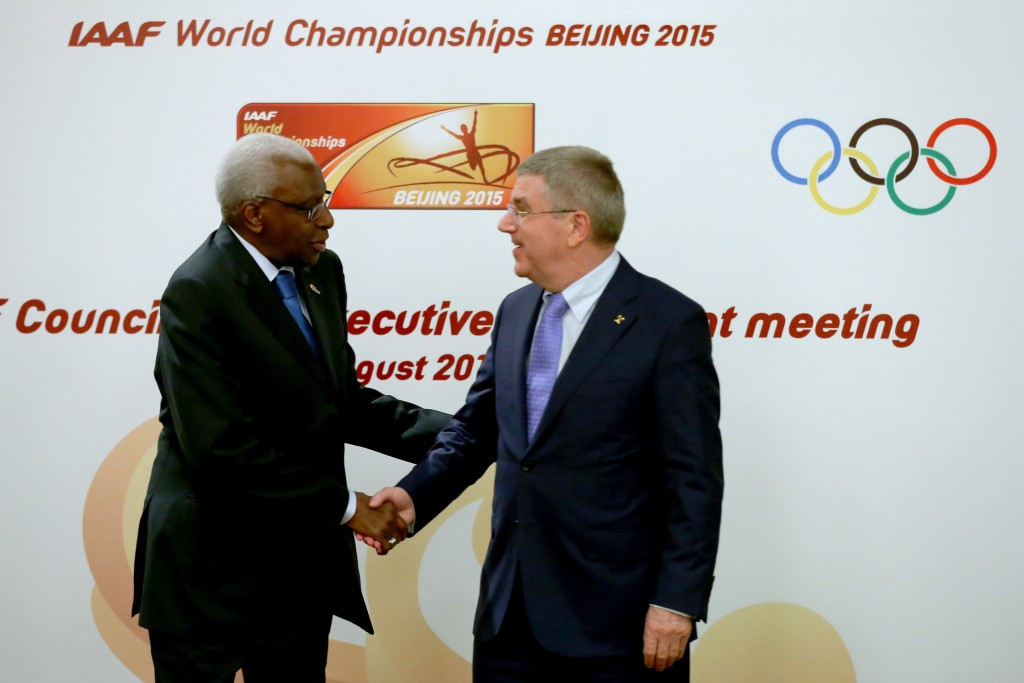 IOC President Thomas Bach (right), pictured with outgoing IAAF President Lamine Diack, said he was emotionally still in favour of life bans for doping, but had accepted it was legally impossible to enforce ©Getty Images
