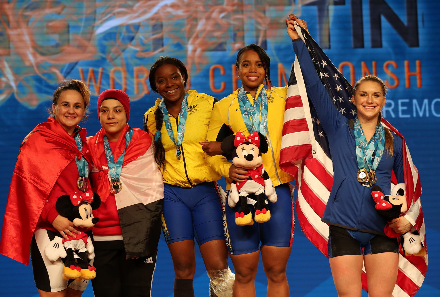 Egypt's Sara Samir Elsayed Mohamed Ahmed, second from left, and Colombia's Miyareth Mendoza Carabali, third from left, also medalled with clean and jerk gold and snatch silver respectively ©IWF