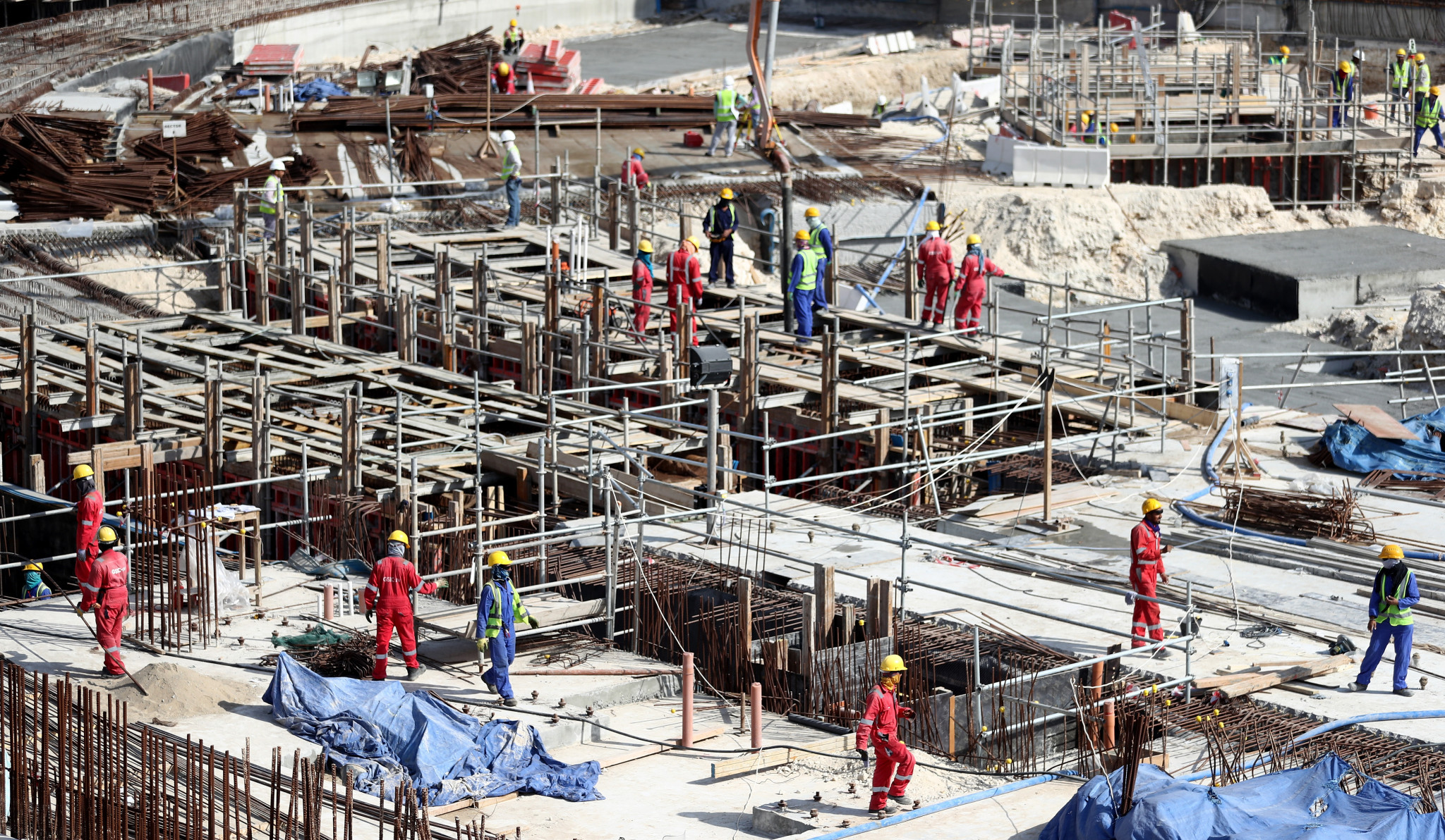 Workers seen during a tour at the construction site of the Al Bayt Stadium and the workers accommodation in January in Doha, Qatar. Al Bayt Stadium will be a host venue for the 2022 FIFA World Cup, which will have a capacity of 60,000 and host matches through to the semi-finals ©Getty Images