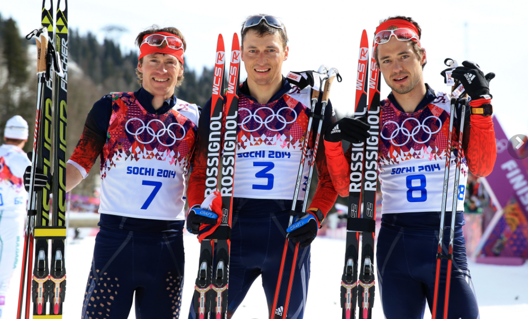 Ilia Chernousov, right, poses with Maxim Vylegzhanin, left, and Alexander Legkov after their clean sweep at Sochi 2014 ©Getty ImagesIlia Chernousov receives his Olympic bronze medal in the 50km mass start cross-country event from IOC President Thomas Bac