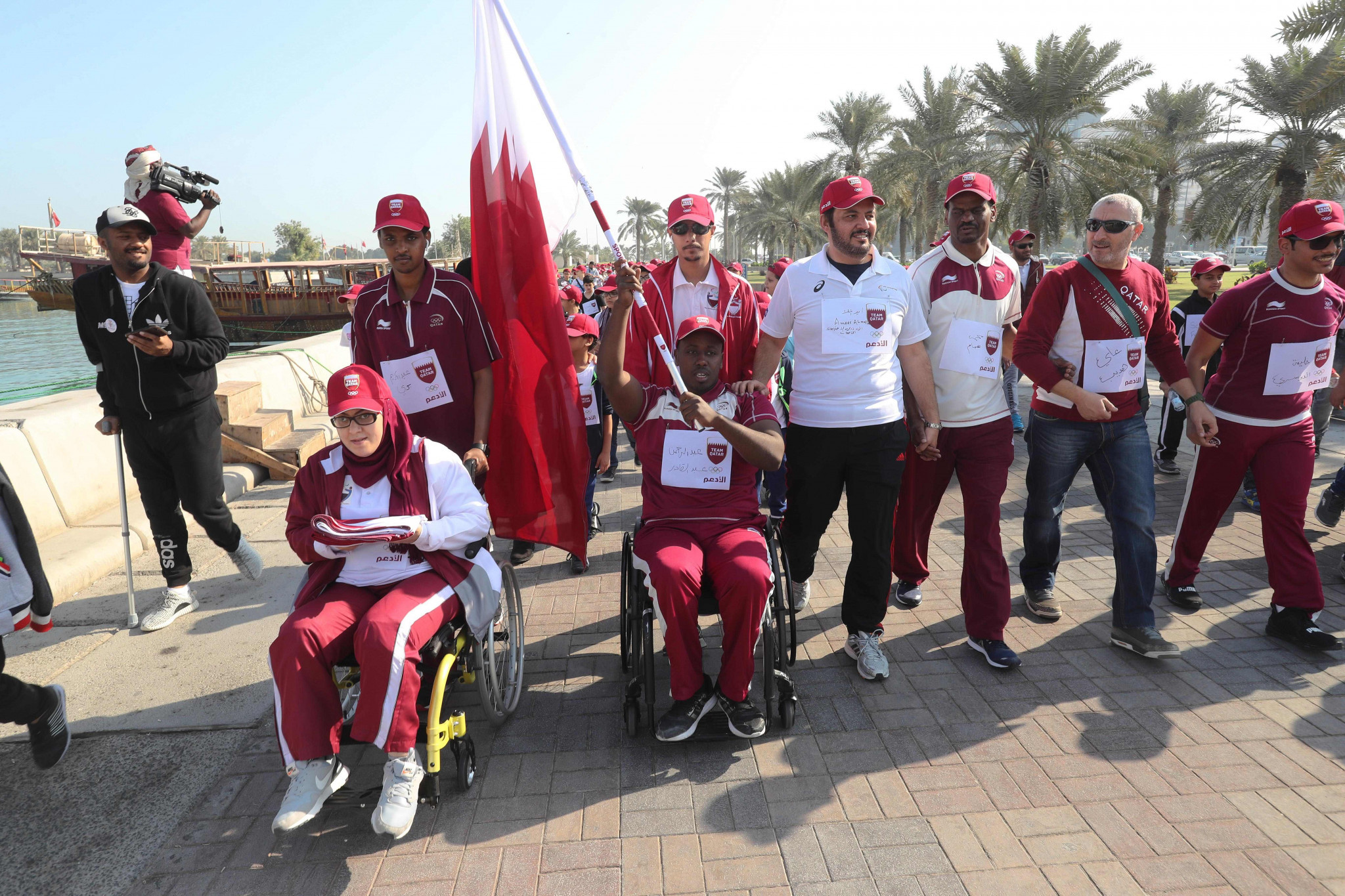 Paralympic athletes Sara Masoud, left,and Abdelrahman Abdelqader, right, carried the flag around Doha Corniche ©Team Qatar