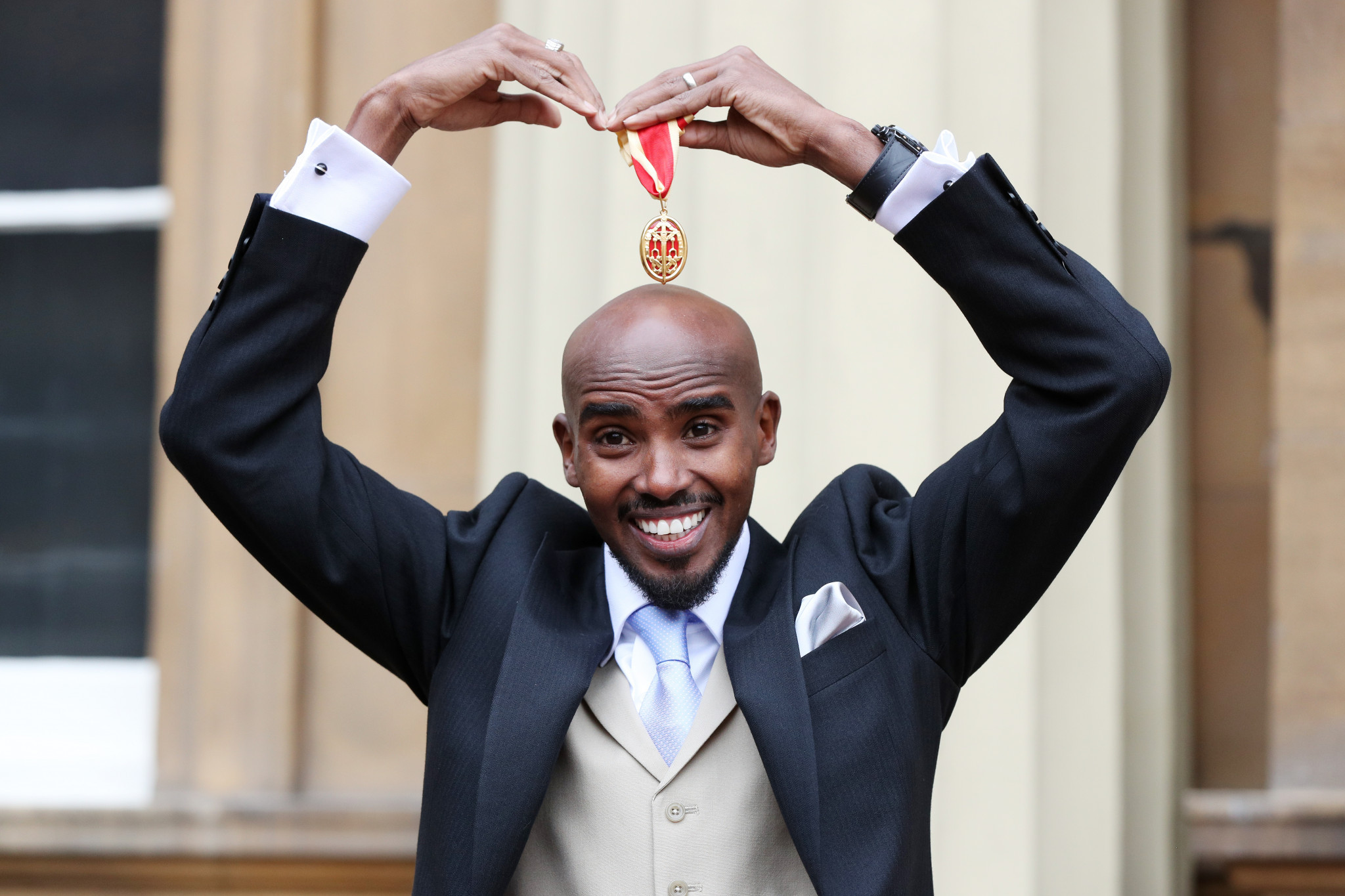 Four-time Olympic champion Sir Mo Farah has had better years but nevertheless, here he does his trademark 'mobot' after receiving his knighthood from Queen Elizabeth II at Buckingham Palace last month ©Getty Images