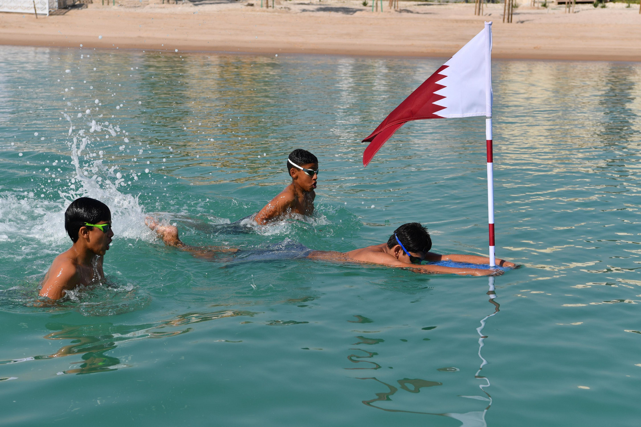 Young Qatari swimmers carried the flag across the Katara to the Pearl ©Team Qatar