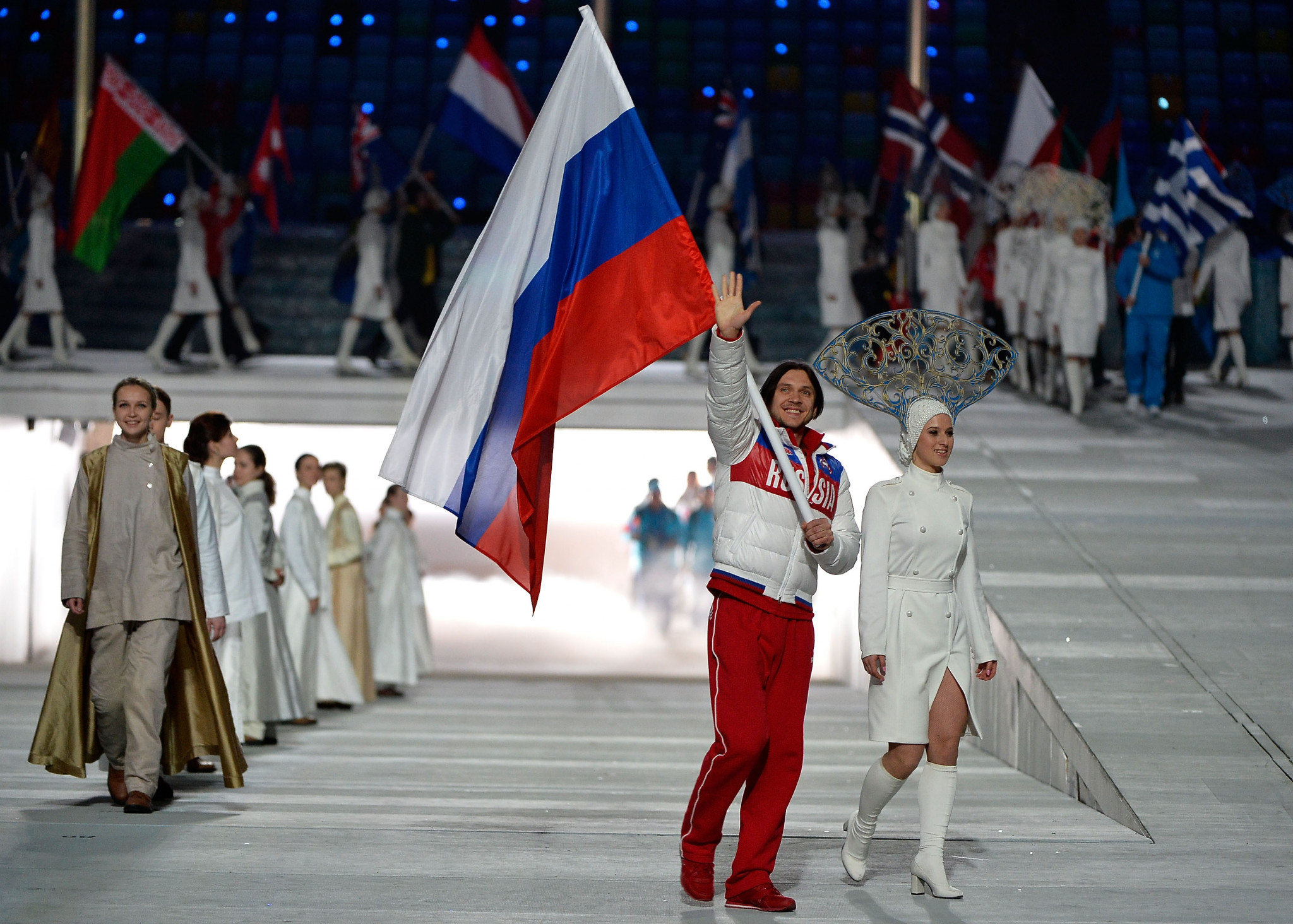 Skater Maxim Trankov enters with the Russian flag during the Closing Ceremony of Sochi 2014 ©Getty Images
