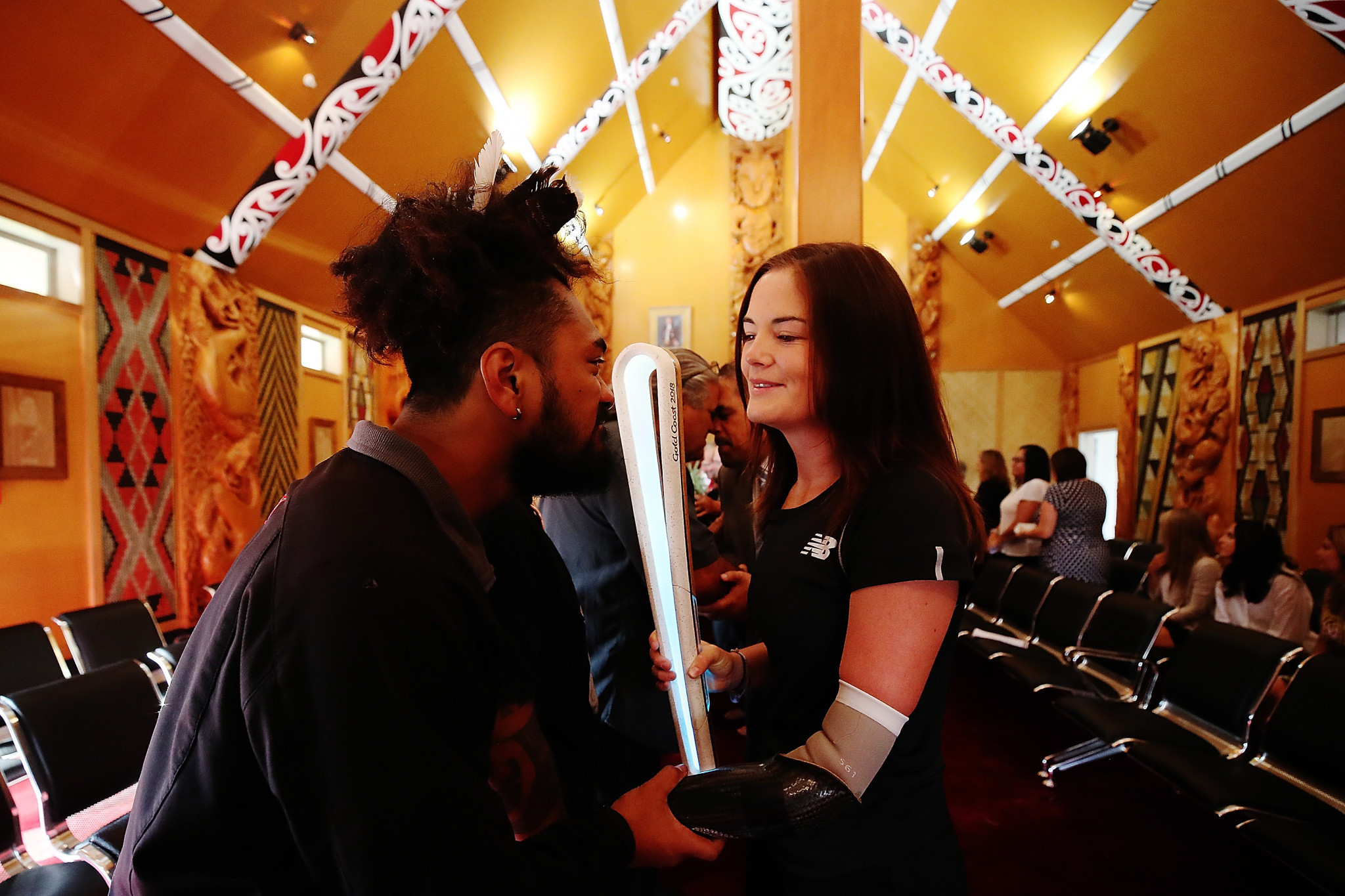 New Zealand Para javelin thrower Holly Robinson greets a Maori warrior during the Commonwealth Games Queen's Baton Relay function at Te Manukanuka o Hoturoa Marae  in Auckland, New Zealand ©Getty Images