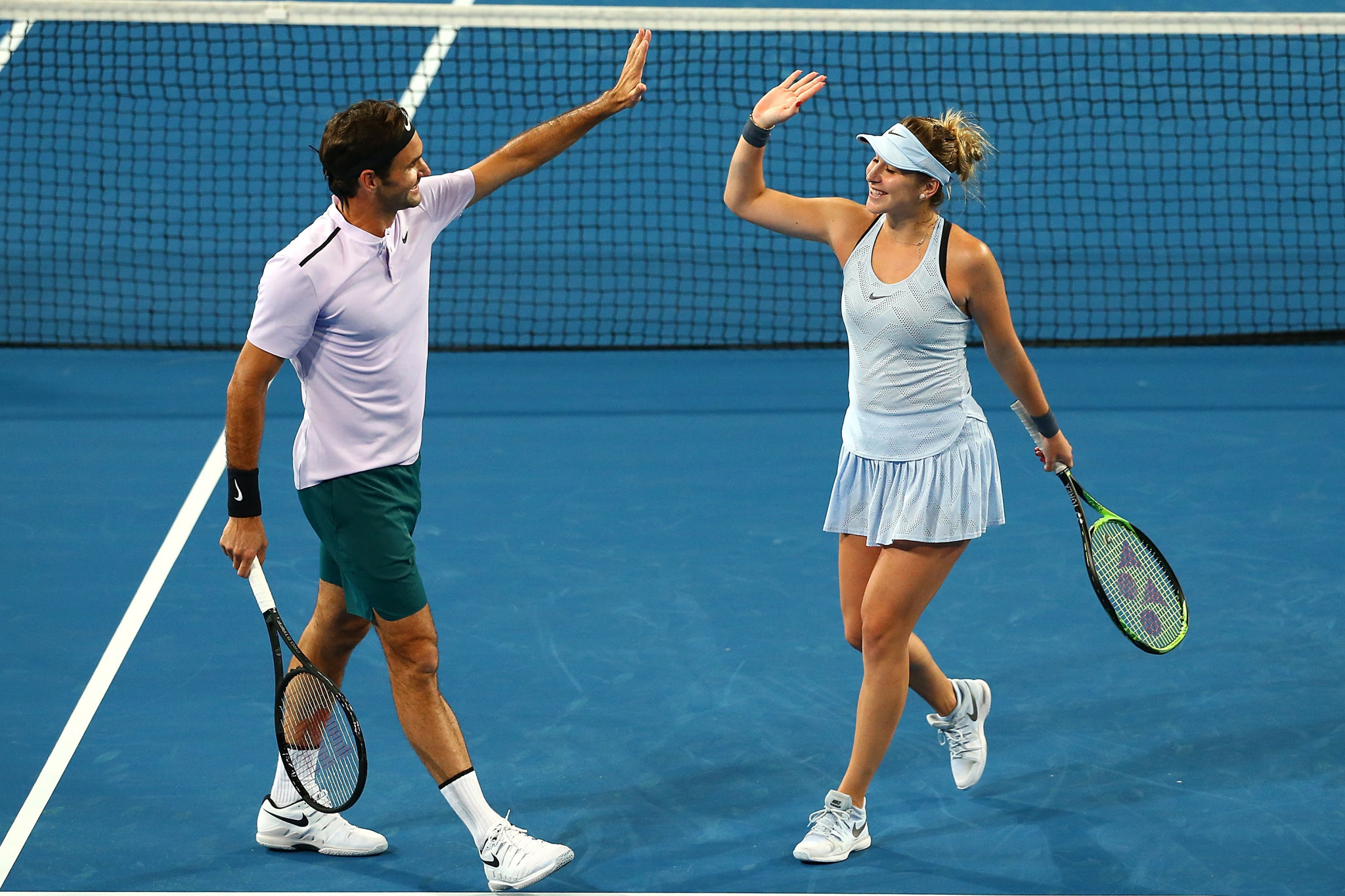 Roger Federer and Belinds Bencic teamed up to win the mixed doubles match to complete a clean sweep for Switzerland ©Getty Images