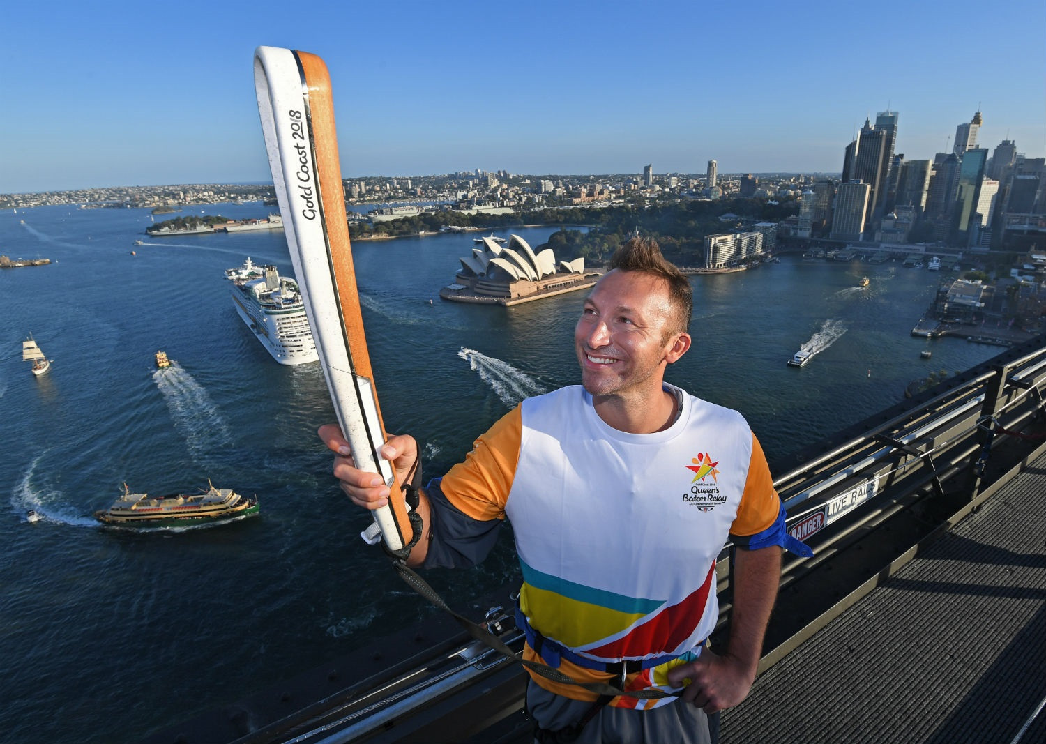 Australian swimming great carries Gold Coast 2018 Queen's Baton on Sydney Harbour Bridge