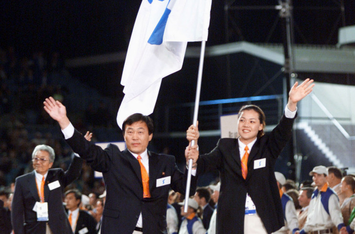 Pak Jang Choo, left, of North Korea, and Chung Eun-Soon of South Korea carry a special flag showing the Korean peninsula as teams from the two Koreas march together for the first time at the Opening Ceremony of the 2000 Sydney Games ©Getty Images