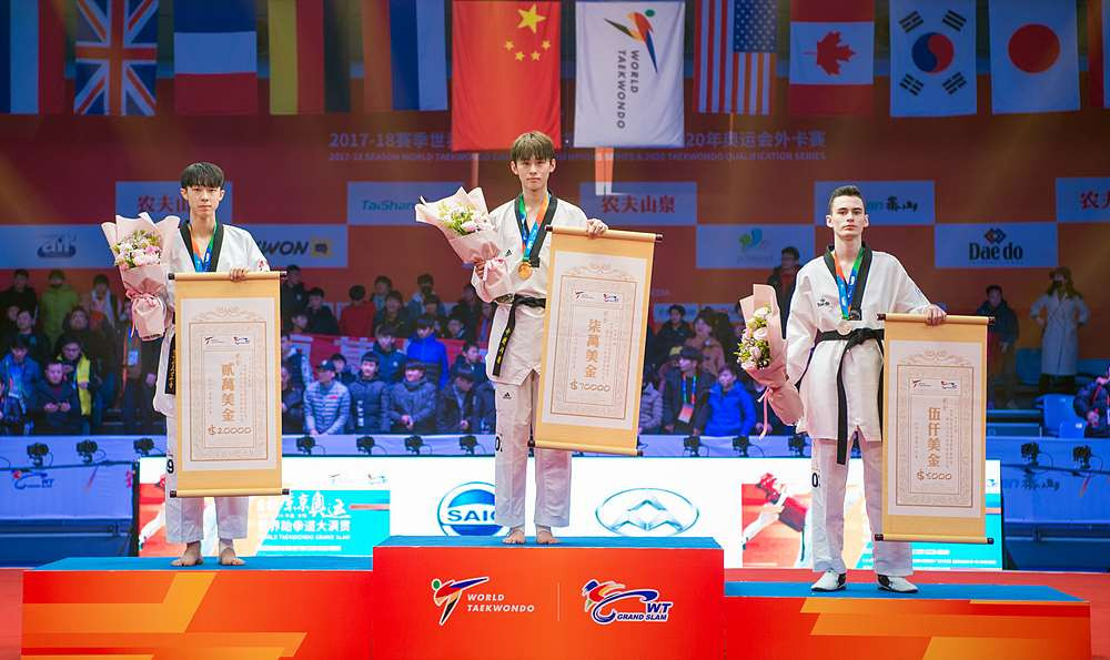 South Korea's Kim Tae-hun, centre, dominated to win the men's under 58kg competition ©World Taekwondo