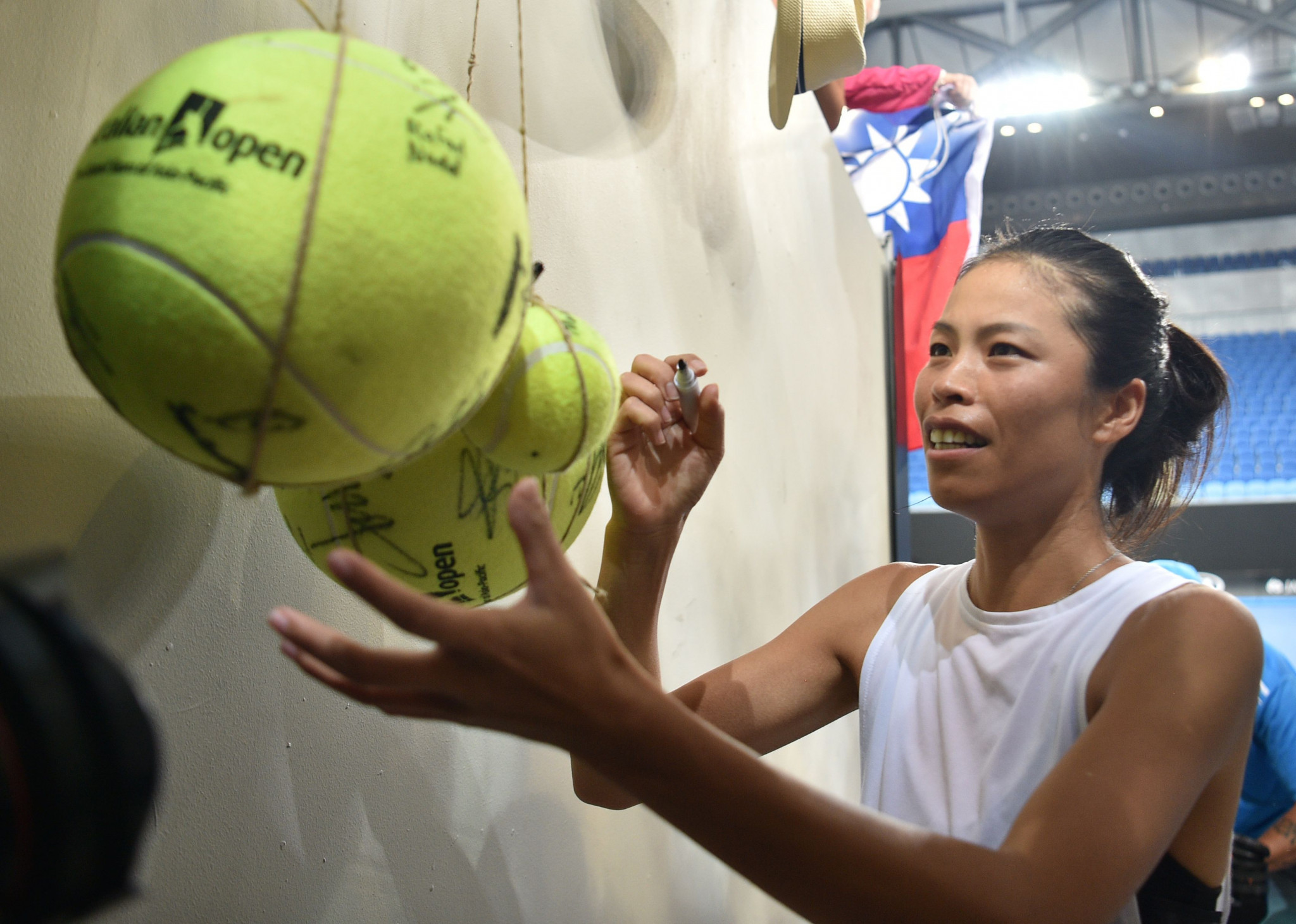 Taiwan's Hsieh Su-Wei signs a giant tennis ball after winning today ©Getty Images