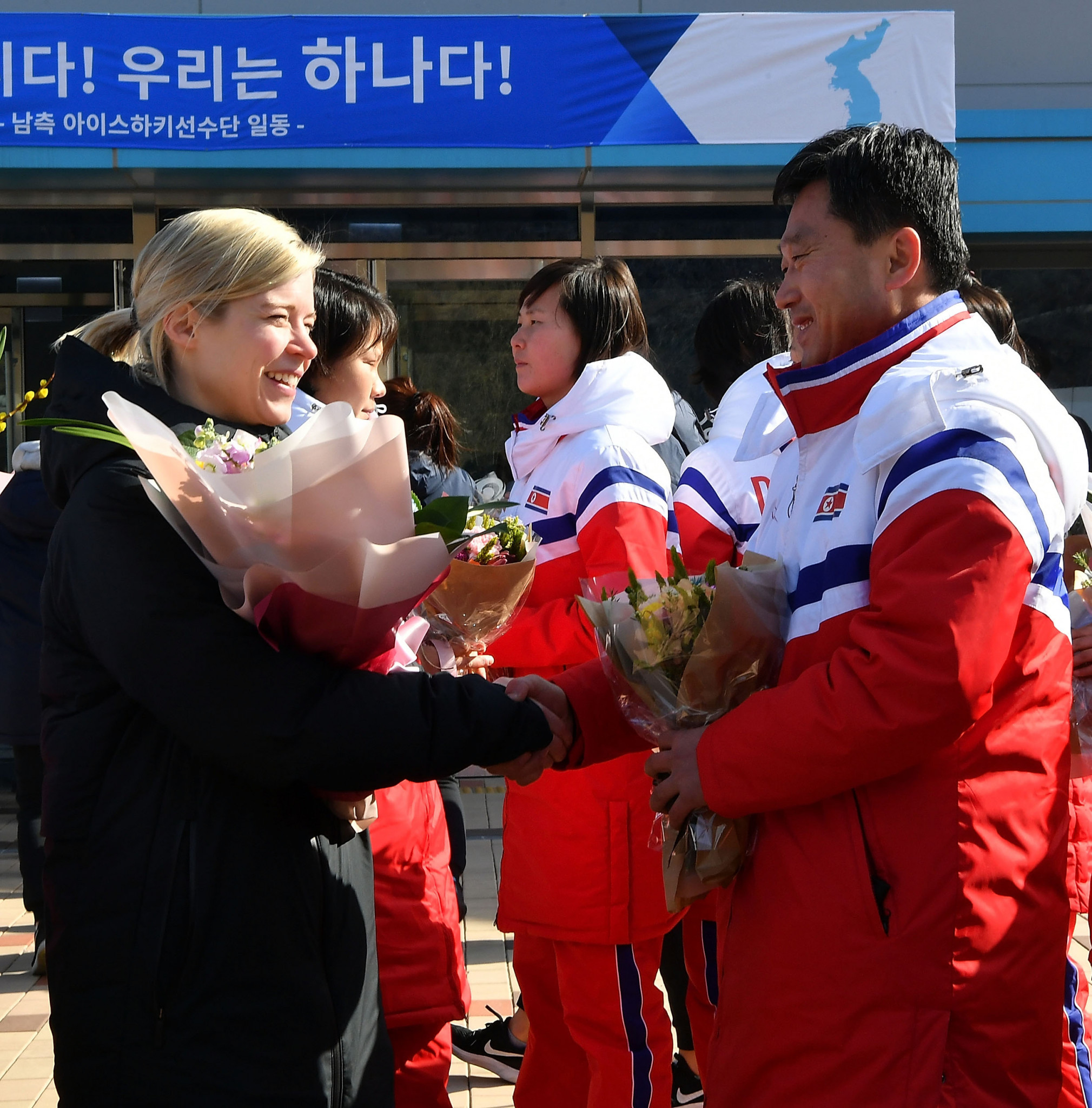 The North Korean delegation was welcomed by the South Korean team, led by coach Sarah Murray ©Getty Images