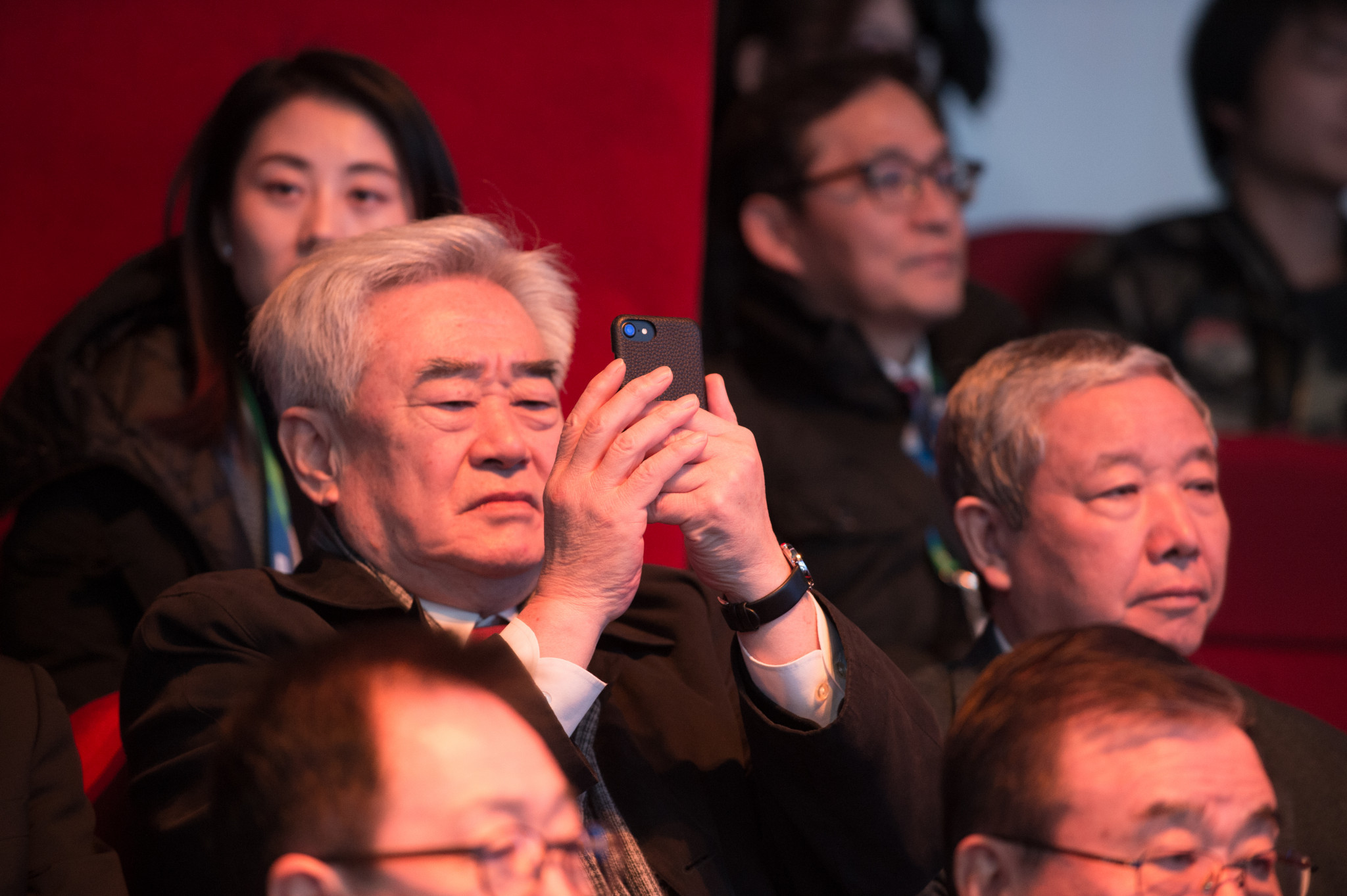 World Taekwondo boss Chungwon Choue, left, photographs the competition while sitting next to China's IOC vice-president Yu Zaiqing ©World Taekwondo