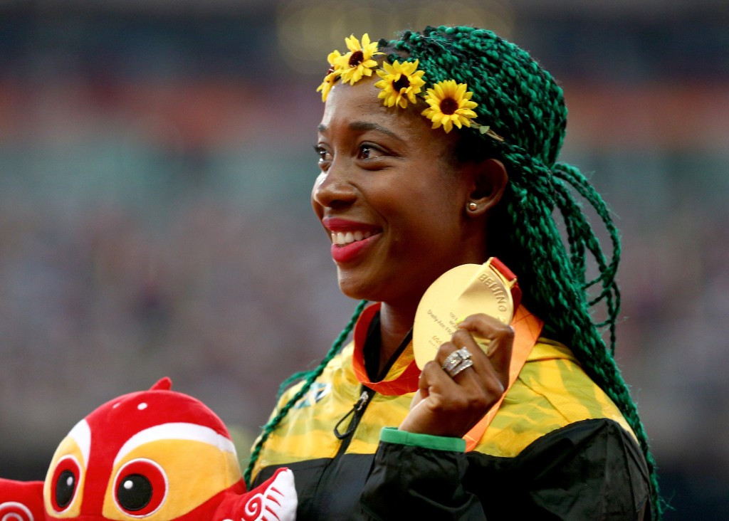 Shelly-Ann Fraser Pryce ran to glory with a green braid and yellow flower hairstyle combination 