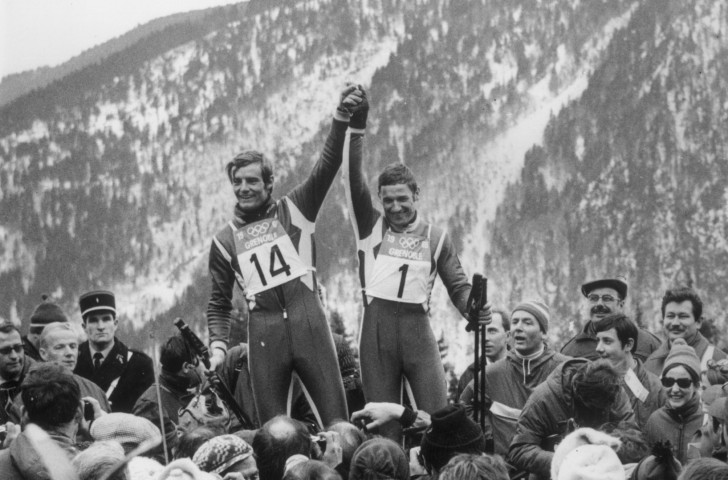 Jean-Claude Killy pictured with silver medallist Guy Périllat after winning the first of his three Winter Olympic gold medals in the downhill at Grenoble 1968  ©Getty Images