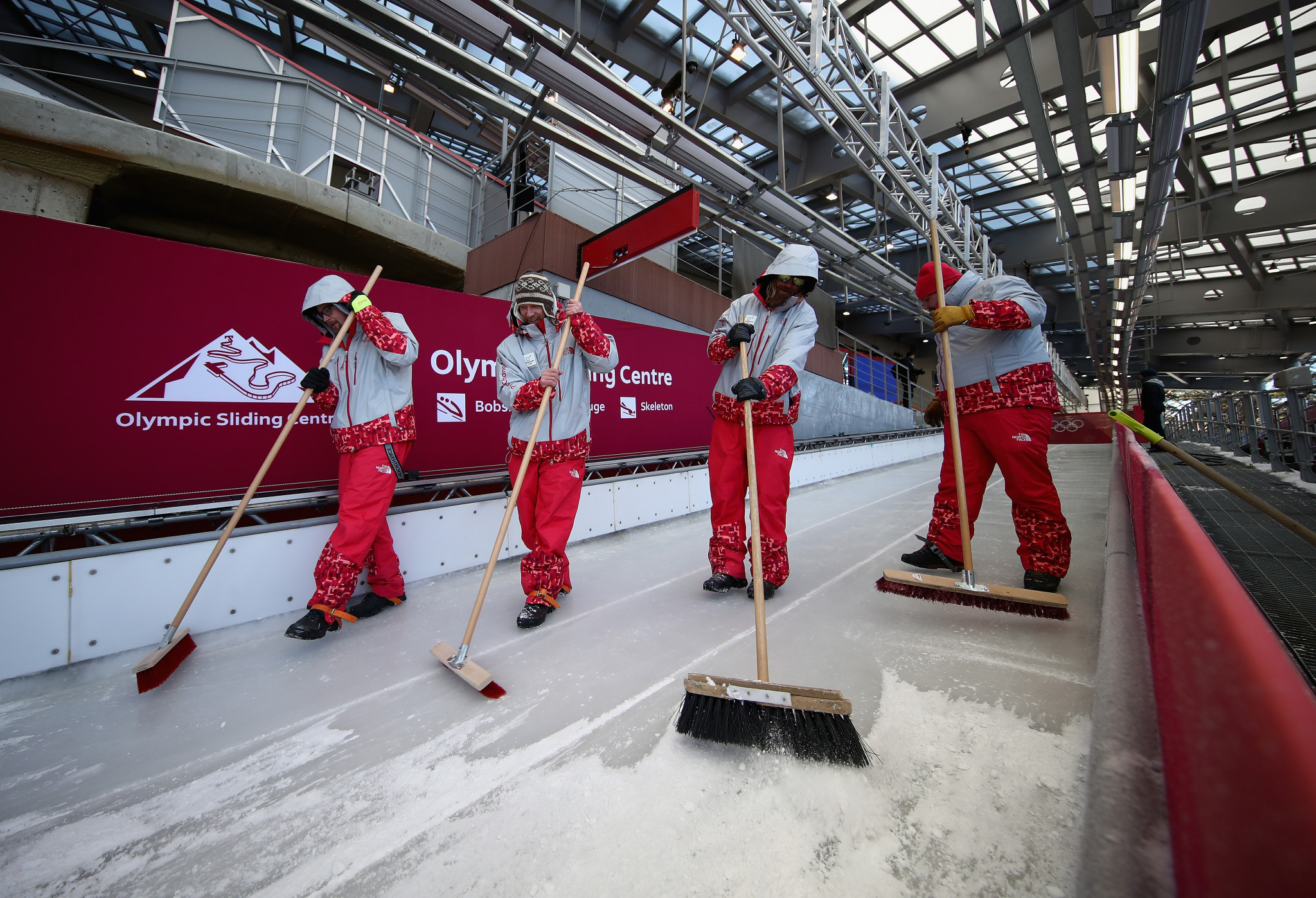 The sliding track is swept before the beginning of training runs ©Getty Images