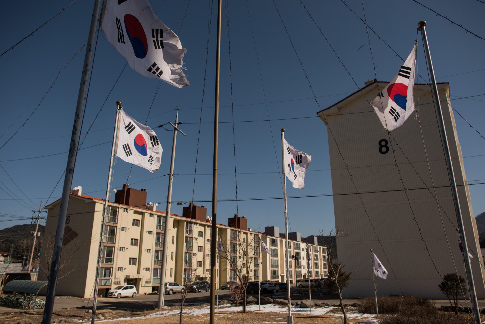South Korean flags fly over apartment buildings where a North Korean cheerleading squad is staying ©Getty Images