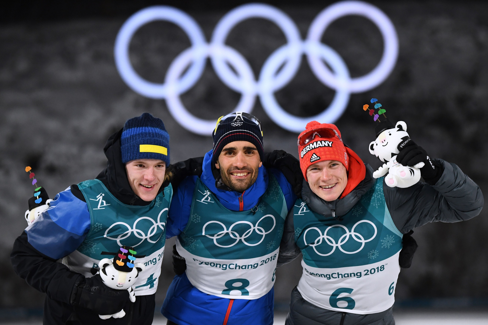 Martin Fourcade, centre, alongside fellow medal winners in the biathlon ©Getty Images