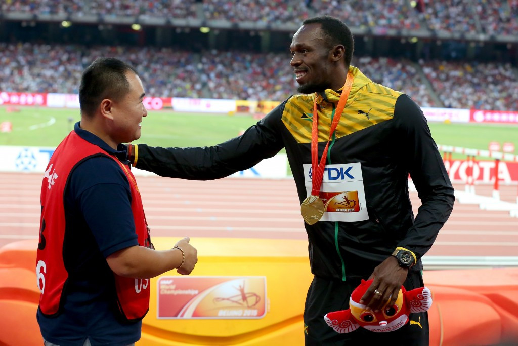 Usain Bolt pictured receiving a bracelet from the cameraman, the only man who got the better of him in Beijing ©Getty Images