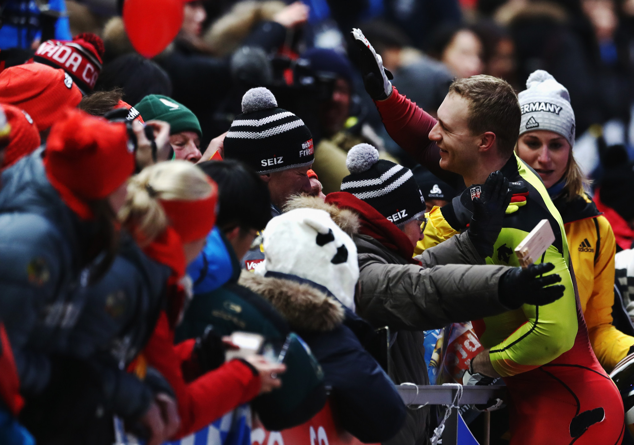 Francesco Friedrich of Germany is mobbed by spectators after winning a share of bobsleigh gold ©Getty Images